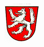 Wappen der Stadt Hauzenberg; In Rot ein steigender silberner Wolf.